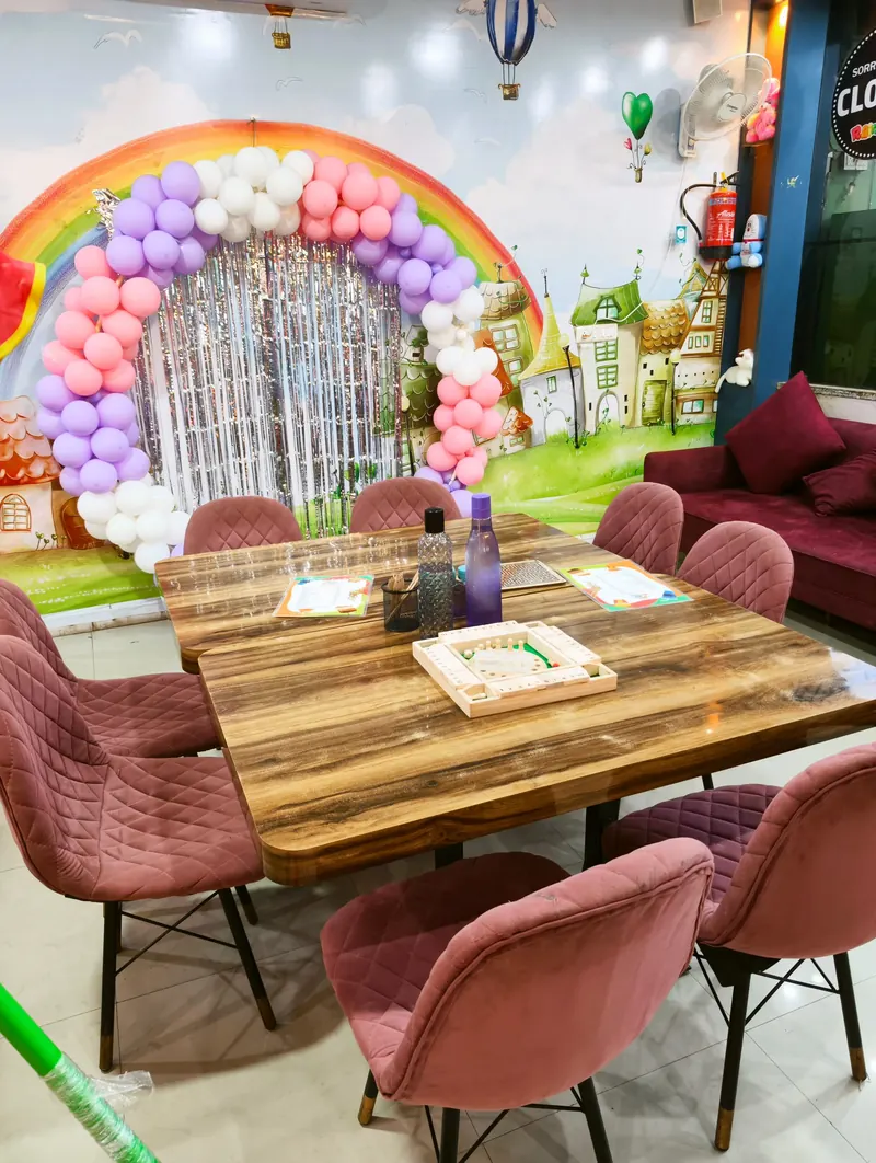 Rainbow-themed party lounge and celebration setup at Rainbow Kids Zone